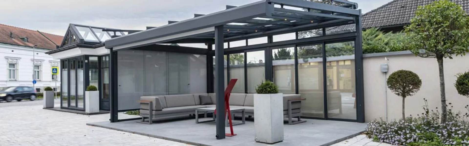 Terrassenüberdachung mit Glasschiebetüren und Beschattungen in unserer Ausstellung in Lanzenkirchen bei Wiener Neustadt.